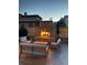 Outdoor stone fireplace creates a magical evening ambiance with comfortable seating for ultimate relaxation at 15179 W Washburn Ave, Lakewood, CO 80228