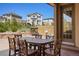 Inviting outdoor patio with dining table, seating, and a lush backyard with mature trees and a privacy fence at 15179 W Washburn Ave, Lakewood, CO 80228