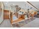 Open bar area with stone pillars, wooden bar, and carpeted stairs nearby at 2094 Lost Canyon Ranch Ct, Castle Rock, CO 80104