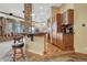 Stylish bar area with stone accents, wooden cabinetry, and seating for entertaining guests at 2094 Lost Canyon Ranch Ct, Castle Rock, CO 80104