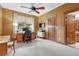 Home office features a large desk, a ceiling fan, and natural lighting at 2094 Lost Canyon Ranch Ct, Castle Rock, CO 80104