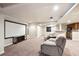 Finished basement area featuring a projector screen, comfortable seating and kitchenette at 11093 Nome St, Commerce City, CO 80640