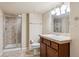 Bathroom featuring a tiled walk-in shower, vanity and updated fixtures at 11093 Nome St, Commerce City, CO 80640