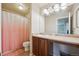 Bright bathroom with a vanity and a shower with a pink curtain at 11093 Nome St, Commerce City, CO 80640