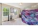 Bedroom with natural light, a desk, and playful artwork at 11093 Nome St, Commerce City, CO 80640