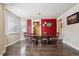 Elegant dining room features a wooden table with seating for six and modern lighting fixture at 11093 Nome St, Commerce City, CO 80640