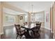 Open-concept dining room featuring hardwood floors, dining table, modern lighting, and ample natural light at 11093 Nome St, Commerce City, CO 80640