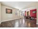 Spacious area with hardwood floors, dining set, and an eye-catching accent wall, perfect for entertaining at 11093 Nome St, Commerce City, CO 80640