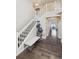 Entryway with hardwood floors, staircase, bench, and stylish cat tree, creating a welcoming first impression at 11093 Nome St, Commerce City, CO 80640