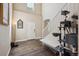 Bright foyer with high ceilings, hardwood floors, and staircase; includes decorative mirror and cat tree at 11093 Nome St, Commerce City, CO 80640