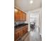 Hallway with wood floors, access to the dining area, featuring stylish cabinets and backsplash at 11093 Nome St, Commerce City, CO 80640