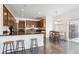 Modern kitchen with dark wood cabinets, granite countertops, and an island with seating at 11093 Nome St, Commerce City, CO 80640