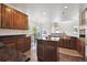 The kitchen showcases wood cabinets, a central island, and sleek granite countertops at 11093 Nome St, Commerce City, CO 80640