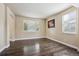 Bright living room featuring hardwood flooring, ample natural light, and neutral decor, great for relaxation at 11093 Nome St, Commerce City, CO 80640
