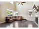Bright living room featuring high ceilings, hardwood floors, fireplace, and abundant natural light at 11093 Nome St, Commerce City, CO 80640