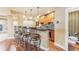 Basement wet bar featuring wood cabinets, granite counters, pendant lights, and barstool seating at 6761 Mary Ct, Castle Pines, CO 80108