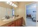 Bathroom with dual sinks, granite vanity and a connecting bedroom at 6761 Mary Ct, Castle Pines, CO 80108
