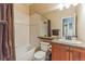 Bathroom featuring white tiles, granite vanity and wood cabinets at 6761 Mary Ct, Castle Pines, CO 80108