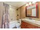 Bathroom featuring tiled shower and granite vanity with dark wood cabinets at 6761 Mary Ct, Castle Pines, CO 80108