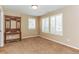 Neutral bedroom showcasing white shutters, carpet floors and an antique display shelf at 6761 Mary Ct, Castle Pines, CO 80108