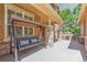 Covered front porch with stone columns, a porch swing, and outdoor seating area at 6761 Mary Ct, Castle Pines, CO 80108