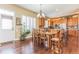 Open dining area with hardwood floors, a view of the kitchen, shutters, and natural light at 6761 Mary Ct, Castle Pines, CO 80108