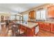Open-concept kitchen with granite countertops, wood cabinets, bar seating, and hardwood floors at 6761 Mary Ct, Castle Pines, CO 80108