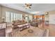 Inviting living room featuring hardwood floors, neutral colors, and ample natural light from shuttered windows at 6761 Mary Ct, Castle Pines, CO 80108