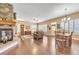 Spacious room featuring a stone fireplace, plantation shutters, hardwood flooring, and adjoining dining area at 6761 Mary Ct, Castle Pines, CO 80108