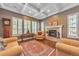 Cozy living room boasts coffered ceilings, a tiled fireplace, and shuttered windows providing ample natural light at 6761 Mary Ct, Castle Pines, CO 80108