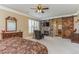 Serene main bedroom with a stone fireplace, hardwood sliding door, and plantation shutters at 6761 Mary Ct, Castle Pines, CO 80108