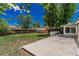 Back yard with shed, concrete patio, fencing, and grass at 770 Havana St, Aurora, CO 80010