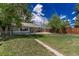 Well-maintained backyard with lush green grass, a patio, and mature trees at 770 Havana St, Aurora, CO 80010