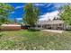 Spacious backyard featuring lush green grass, a shed, and a large patio at 770 Havana St, Aurora, CO 80010