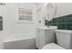 Bathroom featuring classic tiling, a tub, and a window for natural light at 770 Havana St, Aurora, CO 80010