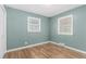 Small bedroom with hardwood flooring and multiple windows at 770 Havana St, Aurora, CO 80010