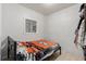 Small bedroom featuring a window, a bed, and a storage closet at 770 Havana St, Aurora, CO 80010
