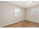 Light-filled bedroom featuring hardwood floors and two windows at 770 Havana St, Aurora, CO 80010