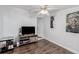 Bedroom with a ceiling fan, wood flooring, and a view towards the entry hallway at 770 Havana St, Aurora, CO 80010