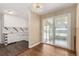 Dining area with hardwood floors connecting to the kitchen and a bright sunroom at 770 Havana St, Aurora, CO 80010