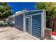 Blue home exterior featuring a storage area or shed, providing additional storage space at 770 Havana St, Aurora, CO 80010