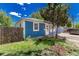 Blue home exterior with a fenced yard and landscaping, offering privacy and curb appeal at 770 Havana St, Aurora, CO 80010
