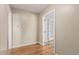Neutral hallway featuring hardwood floors, leading to a room with glass French doors at 770 Havana St, Aurora, CO 80010