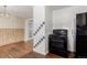 Kitchen with an oven and transition to a dining area with hardwood floors, with black appliances at 770 Havana St, Aurora, CO 80010