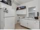 Bright kitchen featuring white appliances, cabinets, and a window above the sink at 770 Havana St, Aurora, CO 80010