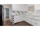 Classic kitchen featuring white cabinets, patterned tile countertops, and stainless steel refrigerator at 770 Havana St, Aurora, CO 80010