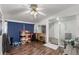 Bonus room with wood laminate flooring, a ceiling fan, and a sliding glass door to the exterior at 770 Havana St, Aurora, CO 80010