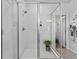 Sleek glass-enclosed shower showcasing a modern design with white tile and a plant for a fresh touch at 3453 N Gold Bug Ct, Aurora, CO 80019