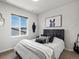 Bedroom featuring a horse portrait, a dark headboard bed with patterned pillows, a vase, and a window view at 3453 N Gold Bug Ct, Aurora, CO 80019