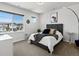 Bright bedroom with a large window offering neighborhood views, complemented by stylish decor and comfortable furnishings at 3453 N Gold Bug Ct, Aurora, CO 80019